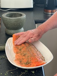 Spices are rubbed onto a fillet of salmon